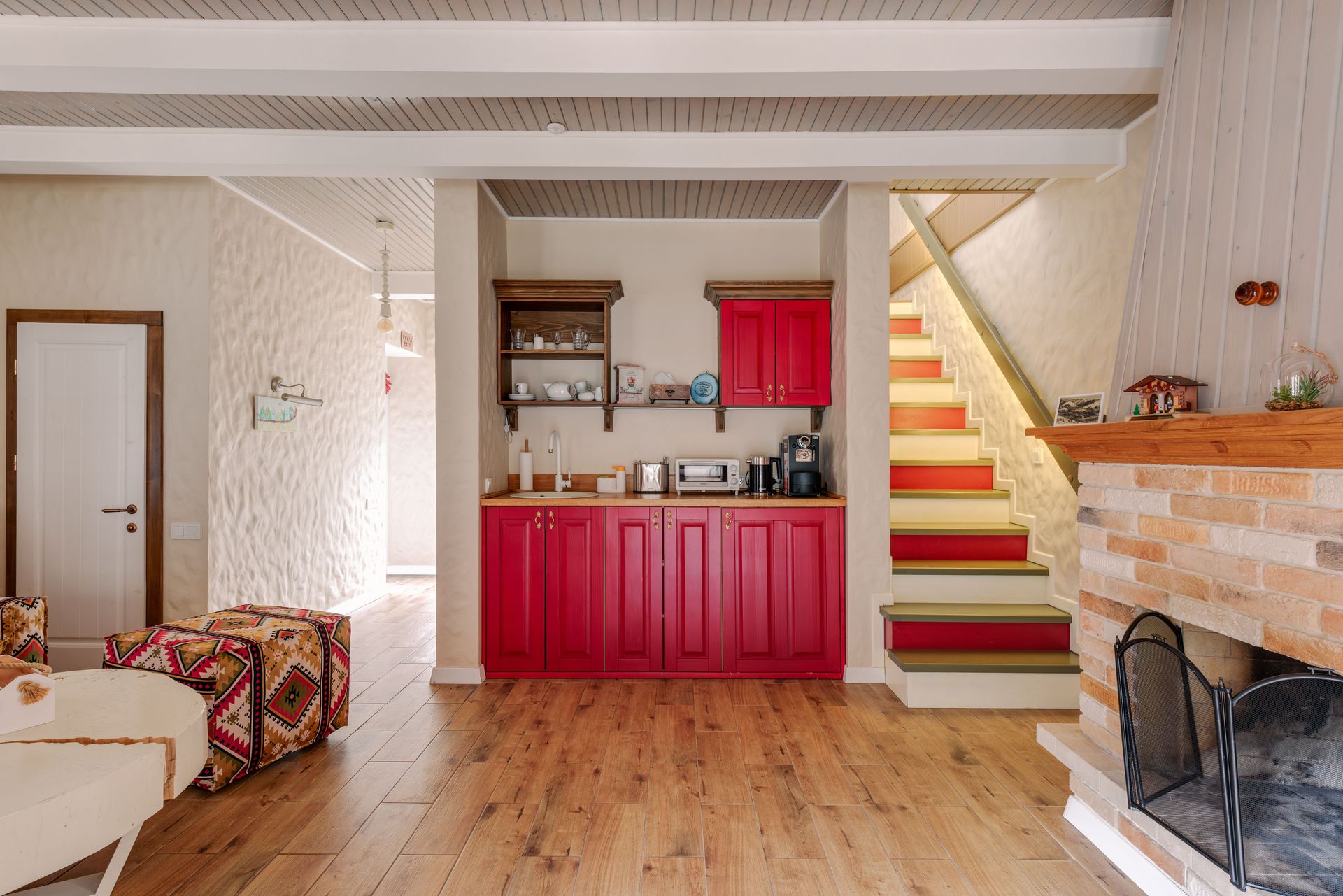 Warm and inviting living room with a modern red cabinetry and fireplace.